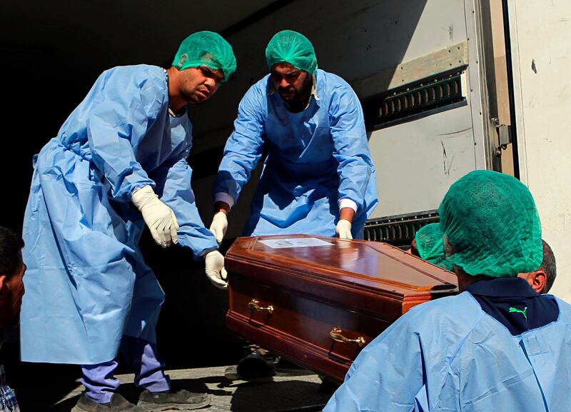 A casket holding one of 38 Indians abducted by the Islamic State group in 2014, that were found in a mass grave outside Mosul, is loaded on a truck to be transported from Baghdad's main morgue to the Baghdad airport, in Iraq, Sunday, April 1, 2018. The remains of 38 Indian construction workers captured and killed by the Islamic State group in northern Iraq were handed over to Indian authorities in Baghdad to be flown home later Sunday. (AP Photo/Khalid Mohammed)