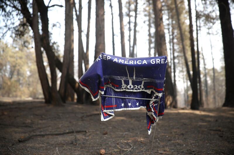 A melted Trump campaign sign sits in front of a home that was destroyed by the Bear Fire in Berry Creek, California. AFP