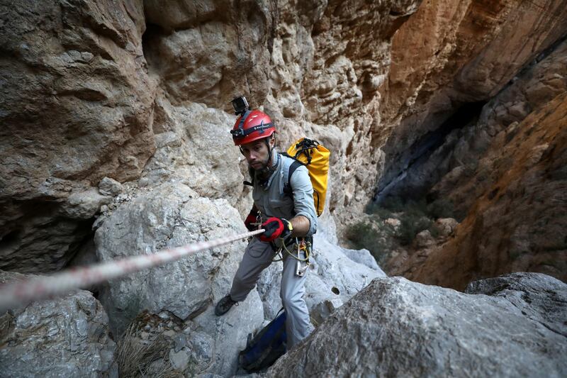 A member of the Middle East Caving and Expeditionary Team descends while exploring Birdwing cave, the deepest in the Gulf, on Jebel Kawr near Ibri, Oman. Reuters
