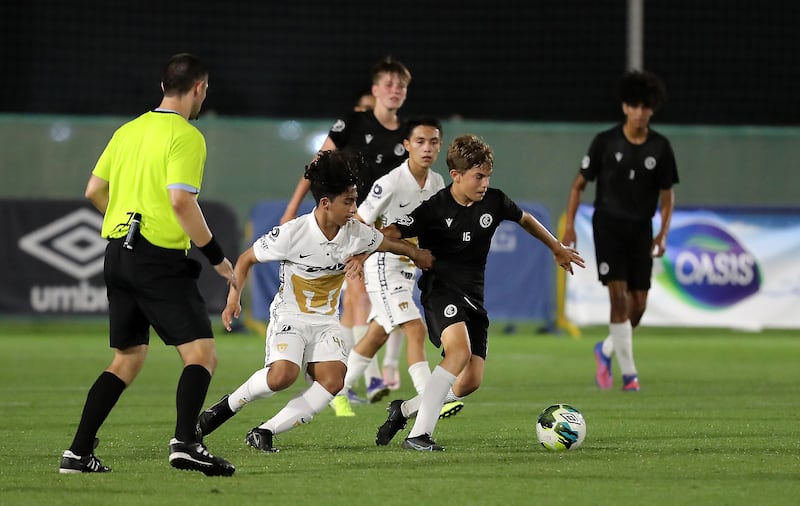 Players in action during the U14 Mina Cup final match between Pumas Unam (white) and Manchester City Football Schools (black) at Jebel Ali Centre of Excellence.