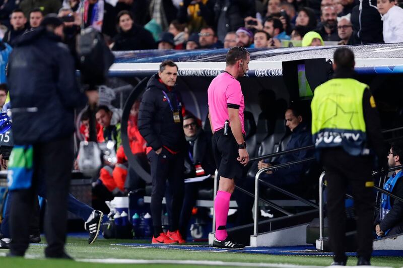 Referee Artur Dias watches the VAR monitor and then reverse his decision. AP