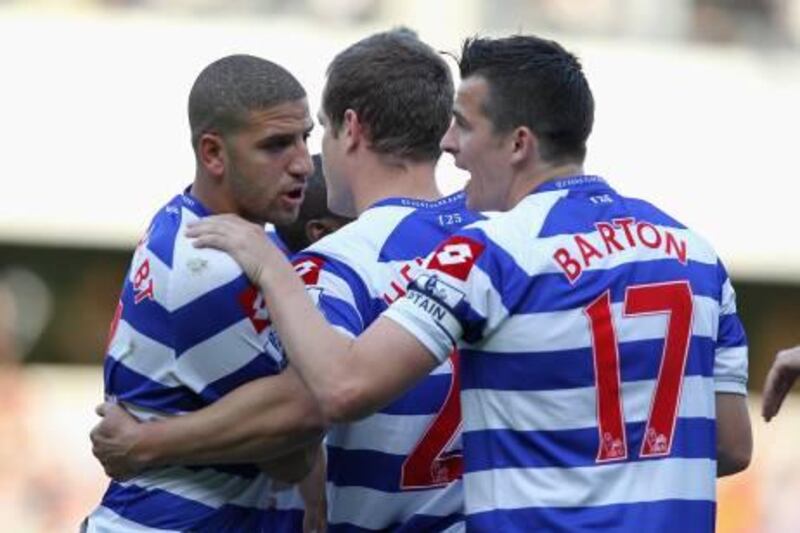 LONDON, ENGLAND - OCTOBER 23:  Adel Taarabt (L) and Joey Barton (R) of Queens Park Rangers celebrate with Heidar Helguson (C) after he scores from a penalty kick during the Barclays Premier League match between Queens Park Rangers and Chelsea at Loftus Road on October 23, 2011 in London, England.  (Photo by Dean Mouhtaropoulos/Getty Images)