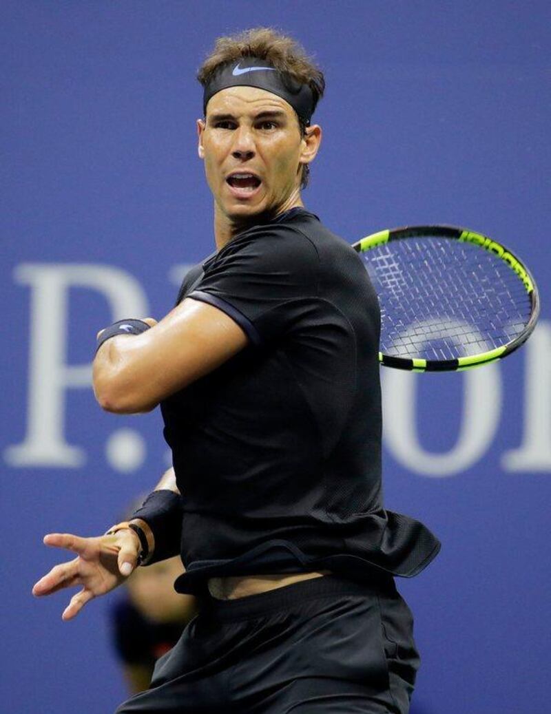 Rafael Nadal returns a shot to Andrey Kuznetsov. Andy Lyons / Getty Images / AFP