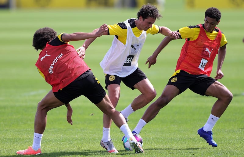 Dortmund's Axel Witsel, Thomas Delaney and Jude Bellingham vie for the ball during the team's first pre-season training session. The 2020/21 Bundesliga will start on September 18. EPA