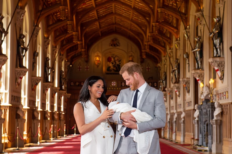 Prince Harry and Meghan pose with their newborn son Archie in St George's Hall at Windsor Castle in May 2019. Getty