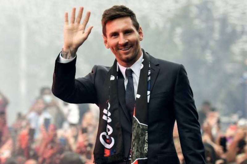 Paris Saint-Germain's Argentinian forward Lionel Messi salutes supporters gathered outside the Parc des Princes.