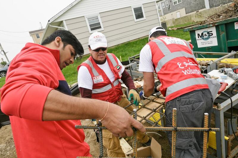 Volunteers including Adel Al Areefi and Hasan Al Ali undertake building work on the home in Sea Bright, New Jersey. The volunteers were coordinated by Takatof, an Emirati organisation that provides humanitarian volunteer opportunities for youth in the UAE.