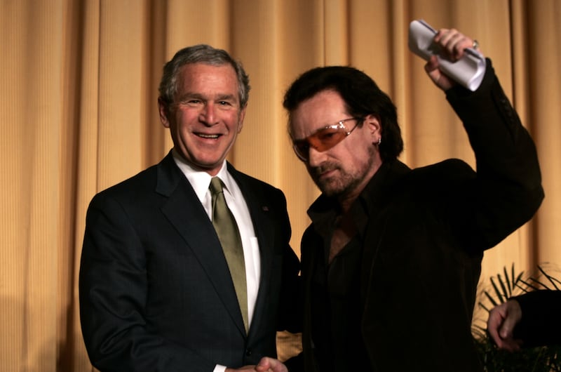 US President George W. Bush stands with Bono following the Irish rocker's speech at the National Prayer Breakfast in Washington DC. Getty Images