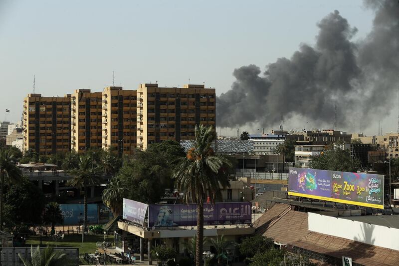 Smoke rises from a storage site in Baghdad, housing ballot boxes from Iraq's May parliamentary election. Thaier Al-Sudani / Reuters