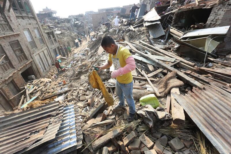 A Nepalese earthquake survivor salvages his belongings from damaged houses in Bhaktapur, near Kathmandu. (Harish Tyagi / EPA)