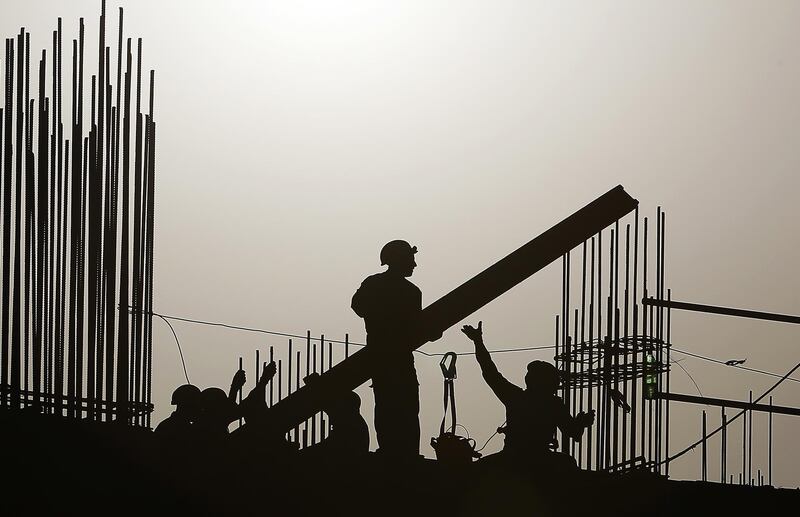 DUBAI, UNITED ARAB EMIRATES , July 5 – 2020 :- Labourers working at one of the construction site during the sunset in Dubai. (Pawan Singh / The National) For News/Standalone/Online/Stock/Instagram
