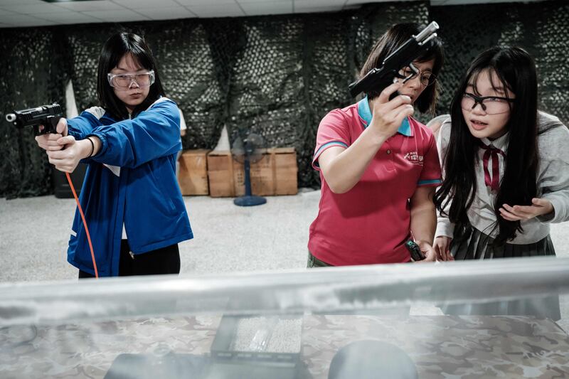 Pupils are taught how to shoot by a Taiwanese military instructor at Kaohsiung Municipal Sanmin Senior High School in Kaohsiung. AFP