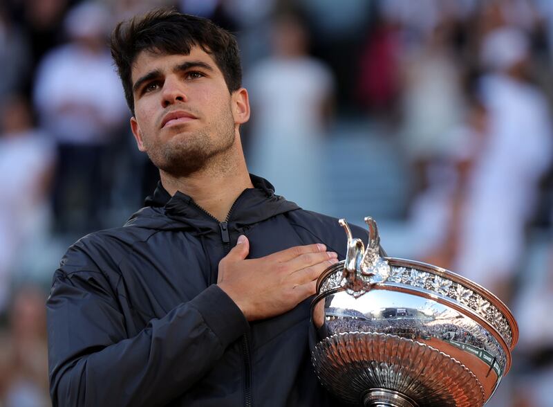 Carlos Alcaraz of Spain poses with the Coupe des Mousquetaires trophy after beating Alexander Zverev of Germany in the French Open final. EPA