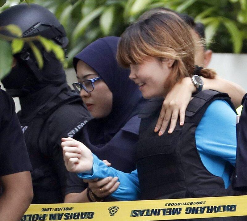 Vietnamese suspect Doan Thi Huong, right, who was arrested in connection with the death of Kim Jong-nam, being escorted by police officers as she leaves a court house in Sepang, Malaysia on April 13, 2017. She is one of two women accused by authorities of swiping Kim's face with VX nerve agent. Vincent Thian/AP Photo