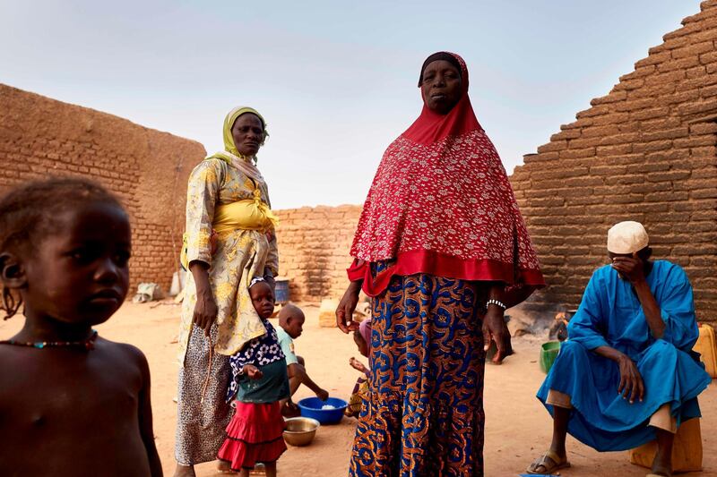 A displaced family stands in a courtyard in Sevare where they found a shelter after fleeing their village of Guerri in central Mali, on February 27, 2020. AFP