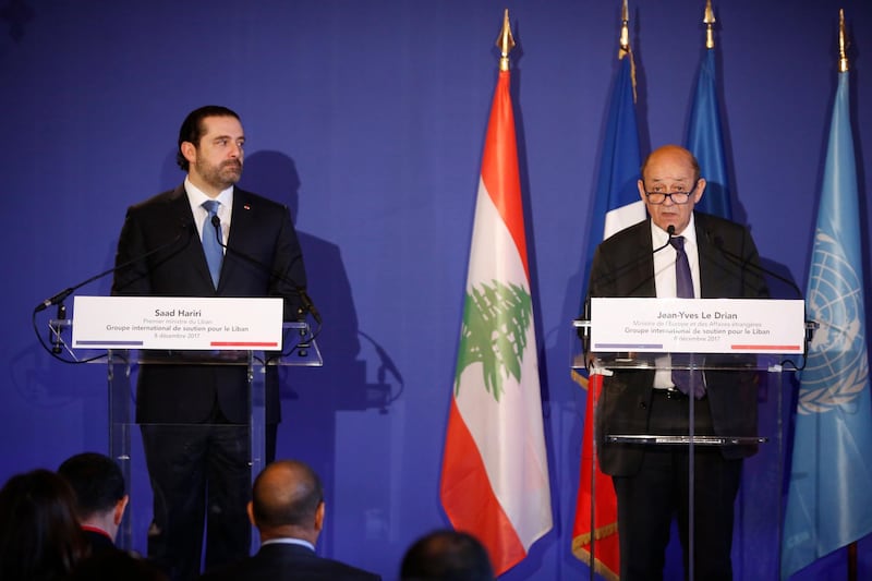 French Foreign Minister Jean-Yves Le Drian, right, and Lebanon's Prime Minister Saad Hariri attend a press conference in Paris, Friday Dec. 8, 2017. It is the first major gathering of key nations to discuss Lebanon's future since a crisis erupted following Hariri's shock resignation last month while in Saudi Arabia. Hariri has since rescinded his resignation. (AP Photo/Thibault Camus)