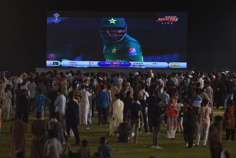 Pakistani youth react as they gather in a park in Islamabad to watch on a big screen. AFP