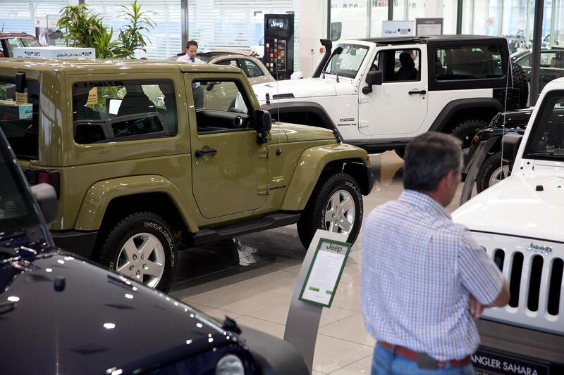 Abu Dhabi, United Arab Emirates, May 27, 2013: 
Potential customers check out one of the latest models of Jeep SUVs as they shop around for a car on Monday, May 27, 2013, at the Emirates Motor Company showroom on Airport Road in Abu Dhabi.
Silvia Razgova / The National

