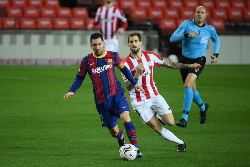 Barcelona's Lionel Messi under pressure from Athletic Bilbao midfielder Dani Garcia. AFP