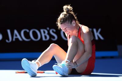 epaselect epa06442347 Simona Halep of Romania grabs her leg before receiving medical treatment in her match against Destanee Aiava of Australia during round one of the Australian Open tennis tournament in Melbourne, Victoria, Australia, 16 January 2018.  EPA/JOE CASTRO  AUSTRALIA AND NEW ZEALAND OUT