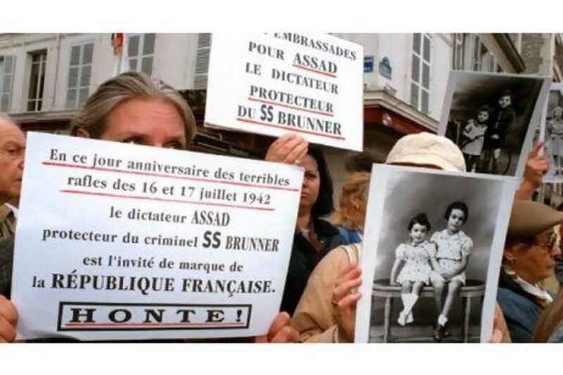 Protesters in France oppose the 1998 state visit by the former Syrian president, Hafez Al Assad, who they believe sheltered the convicted Nazi war criminal Alois Brunner.