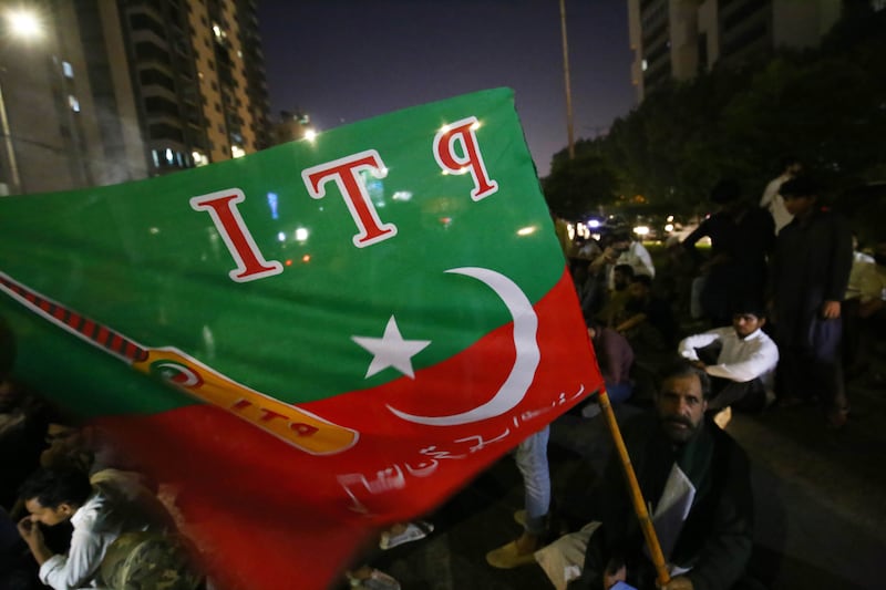 Khan supporters shout slogans during a protest in Karachi. EPA