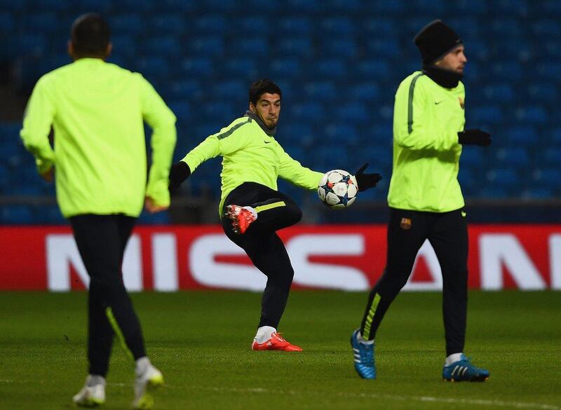 Luis Suarez of Barcelona goes to kick the ball during his team’s training session on Monday ahead of their Tuesday Champions League match against Manchester City. Laurence Griffiths / Getty Images