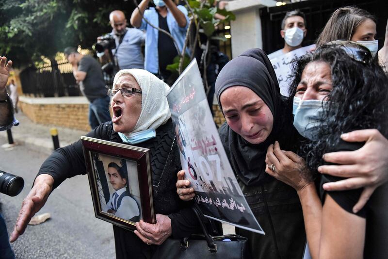 Demonstrators and families of the Beirut blast victims chant slogans during a protest outside the residence of Lebanon's interior minister in the Qoraitem neighbourhood of western Beirut.