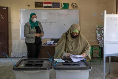 A woman casts her ballot on the first day of the Senate elections in Cairo on August 11. AP