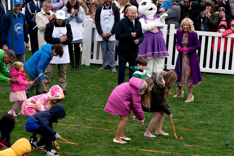 The US President and his wife watch as children compete in the Easter Egg Roll. AFP