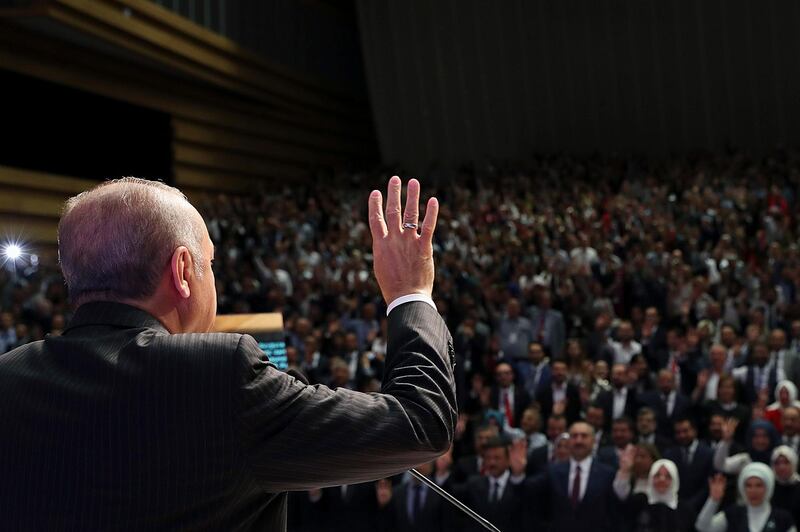 Turkey's President Recep Tayyip Erdogan gestures as he delivers a speech in Ankara, Turkey, Tuesday, Aug. 14, 2018. Erdogan said his country will boycott U.S.-made electronic goods amid a diplomatic spat that has helped trigger a Turkish currency crisis.The Turkish lira has nosedived in value in the past week over concerns about Erdogan's economic policies and after the United States slapped sanctions on Turkey angered by the continued detention of an American pastor.(Pool Photo via AP)
