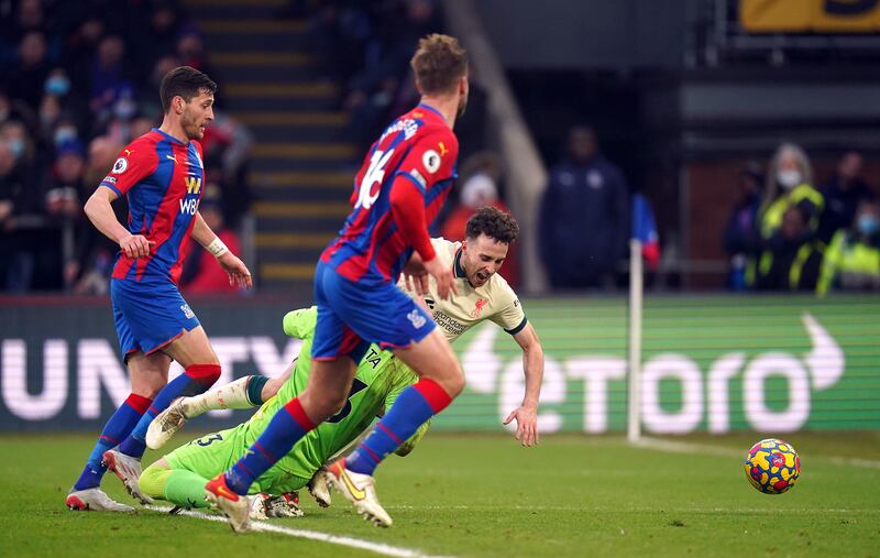 Liverpool's Diogo Jota goes down under a challenge from Crystal Palace goalkeeper Vicente Guaita and a penalty is awarded after a VAR check. PA