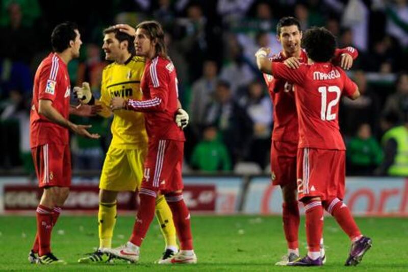 Real Madrid's players celebrate after their Spanish First Division soccer match against Real Betis at Benito Villamarin stadium in Seville March 10, 2012. Cristiano Ronaldo (2nd R) netted his 31st and 32nd La Liga goals of the season to lift Real Madrid to a 3-2 comeback win at Real Betis on Saturday that stretched their lead over second-placed Barcelona to 13 points. REUTERS/Marcelo del Pozo (SPAIN - Tags: SPORT SOCCER)
