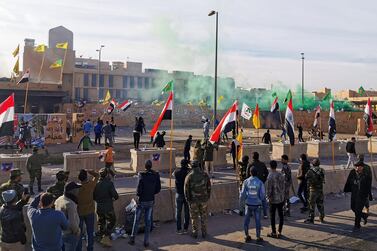 Protesters and militia fighters gather to condemn air strikes on bases belonging to Hashd al-Shaabi (paramilitary forces), outside the U.S. Embassy in Baghdad, Iraq January 1, 2020. REUTERS/Thaier al-Sudani