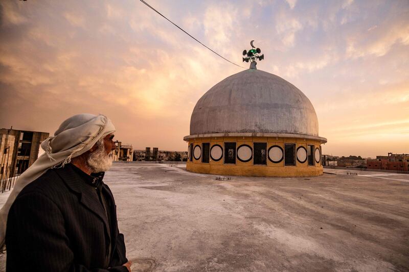 A man stares at the dome of a mosque, in Syria's northern city of Raqa. AFP