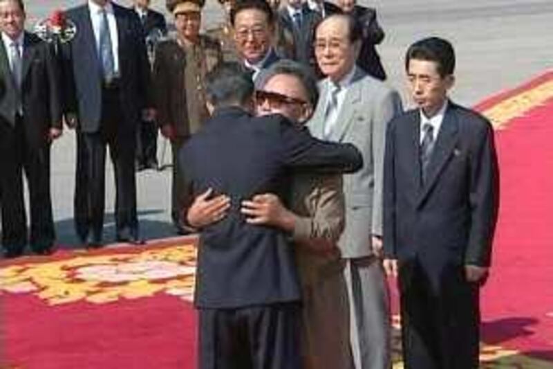 China's Premier Wen Jiabao (L) hugs North Korea's leader Kim Jong-il upon his arrival in Pyongyang in this October 4, 2009 video grab. Kim held talks with Wen on Sunday after making a rare appearance to greet his guest at the start of a visit likely to test the North's stance on nuclear disarmament. 
  REUTERS/KRT via Reuters TV  (NORTH KOREA POLITICS) NORTH KOREA OUT. NO COMMERCIAL OR EDITORIAL SALES IN NORTH KOREA *** Local Caption ***  SIN95_KOREA-NORTH-C_1004_11.JPG