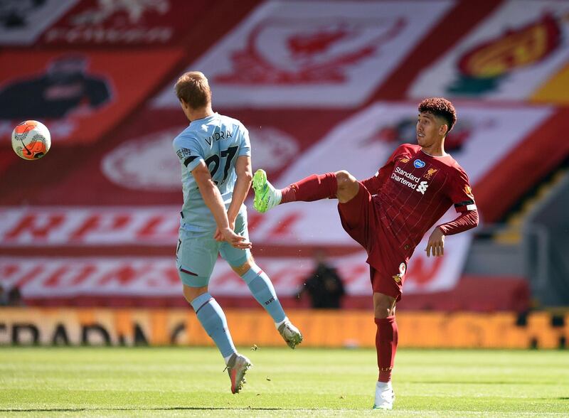 Burnley's Matej Vydra challenges Liverpool's Roberto Firmino at Anfield. AFP