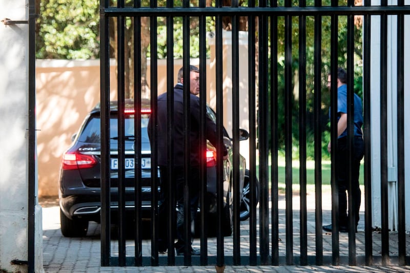 Private security agents escort a car into the compound of the Gupta family in Johannesburg. South African police raided the house of the Gupta family, which is accused of playing a central role in alleged corruption under scandal-tainted President Jacob Zuma. Wikus de Wet / AFP Photo