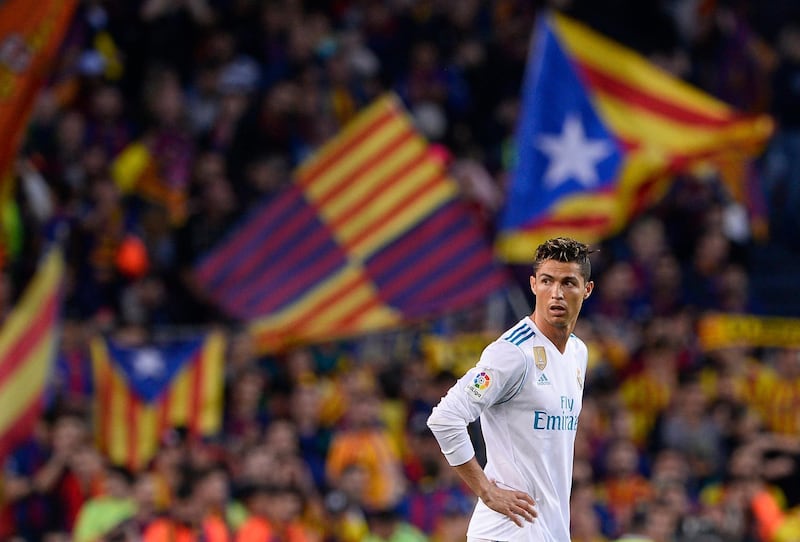 Real Madrid's Portuguese forward Cristiano Ronaldo stands on the field after Barcelona's goal during the Spanish league football match between FC Barcelona and Real Madrid CF at the Camp Nou stadium in Barcelona on May 6, 2018. / AFP PHOTO / Josep LAGO