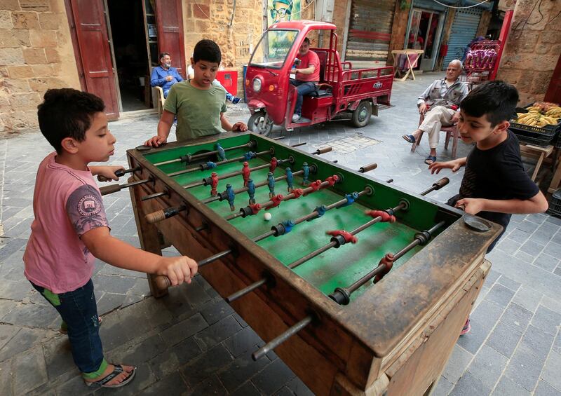 Boys play foosball table game, during a countrywide lockdown to prevent the spread of the coronavirus disease in Sidon, Lebanon. Reuters