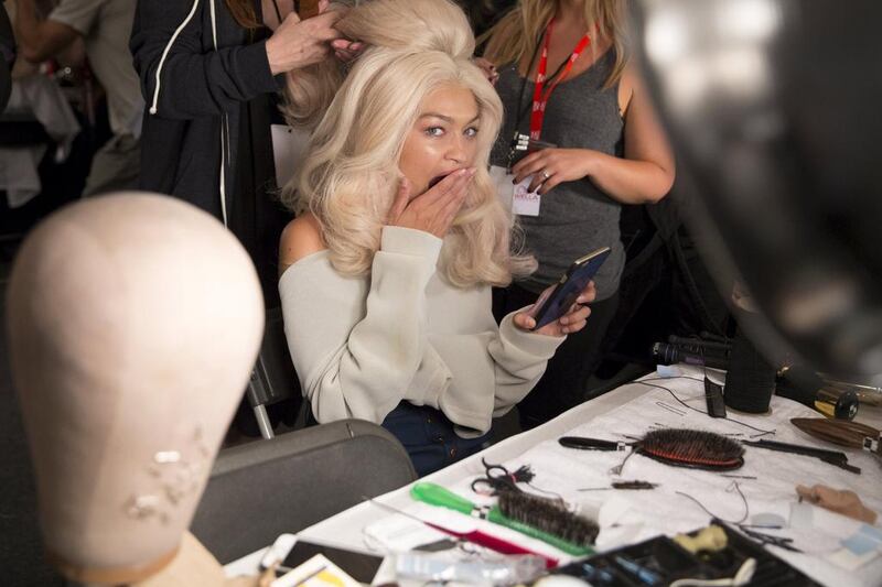 Gigi Hadid yawns as she is prepared backstage before the Jeremy Scott Spring/Summer 2016 collection presentation during New York Fashion Week in New York, September 14, 2015. Andrew Kelly / Reuters