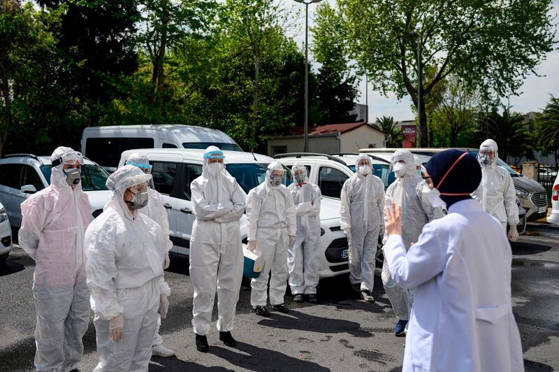 Head of Fatih District Health Department Melek Nr Aslan briefs her staff before they leave to collect swab samples from confined people who are believed to have been in contact with coronavirus patients, in Istanbul. AFP