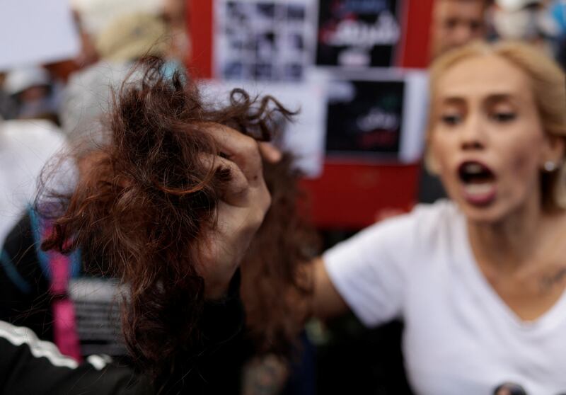 A demonstrator holds cut hair during a protest near the Iranian consulate in Istanbul. Reuters