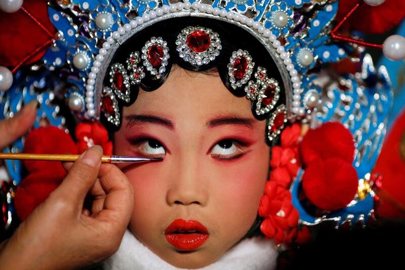 A participant has her make-up done during a traditional Chinese opera competition at the National Academy of Chinese Theatre Arts in Beijing, China. Thomas Peter / Reuters