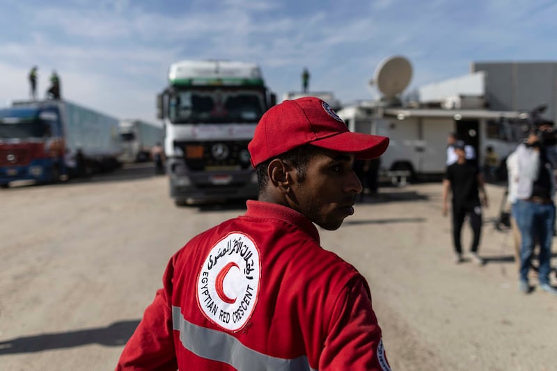 An Egyptian Red Crescent worker at the Rafah border crossing in North Sinai watches aid convoy lorries cross into Gaza on October 21 to make the first deliveries since the conflict began on October 7. Getty Images