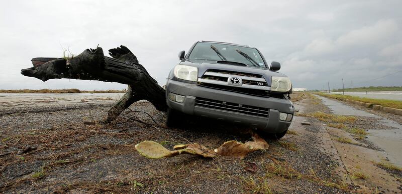 A car abandoned on a coastal highway near Port Lavaca, Texas, rests against debris from Hurricane Harvey. Charlie Riedel / AP Photo