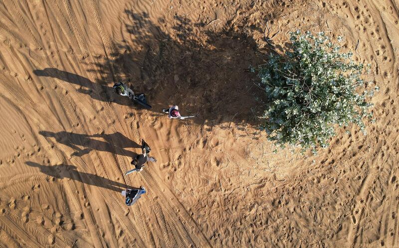 SHARJAH, UNITED ARAB EMIRATES , January 16– 2021 :- Members of the off roaders club collecting trash during the desert clean up drive at the Al Badayer desert area in Sharjah. (Pawan Singh / The National) For News/Stock/Online/Instagram/Standalone/Big Picture. Story by Nick Webster