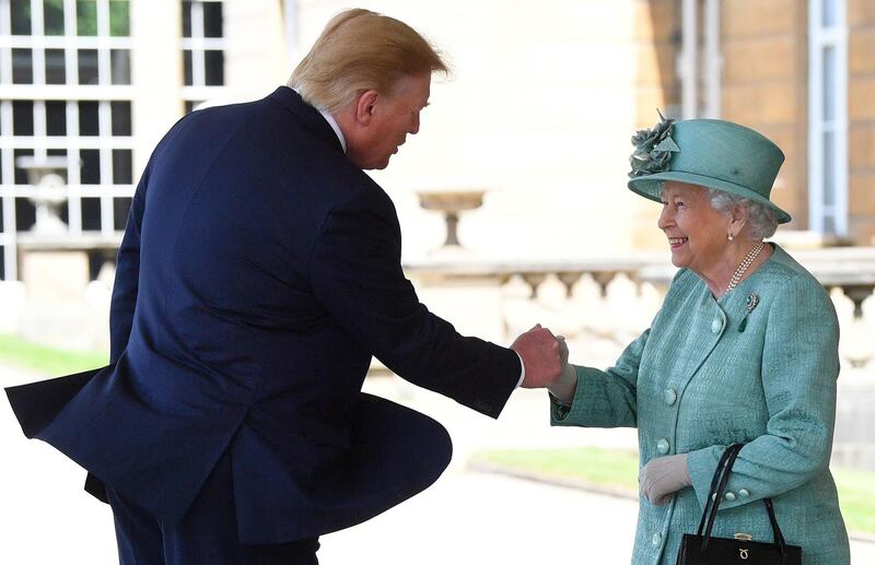 Britain's Queen Elizabeth II (R) shakes hands with US President Donald Trump during a welcome ceremony at Buckingham Palace in central London. AFP