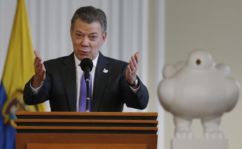 Colombia's President Juan Manuel Santos speaks to supporters of the peace deal he signed with rebels of the Revolutionary Armed Forces of Colombia, FARC, at the presidential palace in Bogota (AP Photo/Fernando Vergara)
