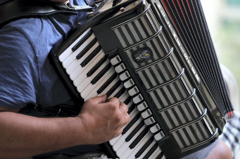 Dubai, United Arab Emirates - Reporter: Rory Reynolds: Boki Prekovic, a Serbian accordion player keeping residents stuck at home entertained from his balcony. Thursday, March 19th, 2020. The Greens, Dubai. Chris Whiteoak / The National